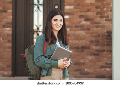 Portrait Of Young Female Student With Beautiful Smile Using Tablet In College Or Private School, Technology Learning Concept.