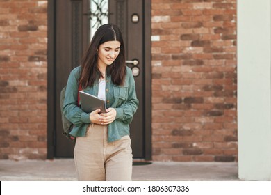 Portrait Of Young Female Student With Beautiful Smile Using Tablet In College Or Private School, Technology Learning Concept. Technology, Education