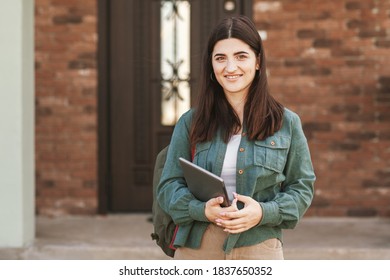 Portrait Of Young Female Student With Beautiful Smile Using Tablet In College Or Private School, Technology Learning Concept.Technology, Education, Leisure Concept