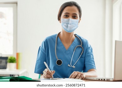 Portrait of young female surgeon writing notes at desk - Powered by Shutterstock