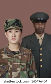 Portrait Of Young Female US Marine Corps Soldier With Male Officer In Background