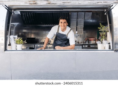 Portrait of a young food truck owner. Food truck owner waiting for customers. - Powered by Shutterstock