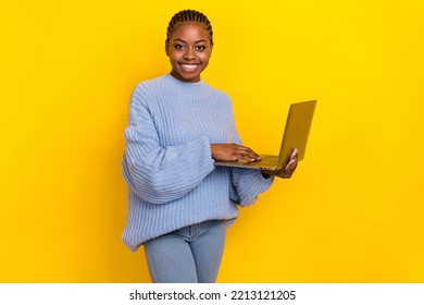 Portrait of young freelancer lady wear blue sweater working laptop doing copyrite content isolated on bright yellow color background - Shutterstock ID 2213121205