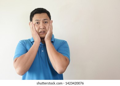 Portrait Of Young Funny Asian Man Shocked Or Surprised Expression With Mouth Open, Worried To See Something Bad Happen