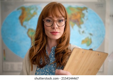 Portrait Of Young Geography Teacher Looking At Camera In Classroom