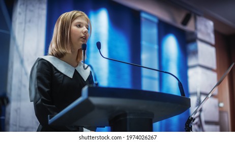 Portrait of an Young Girl Activist Delivering an Emotional and Powerful Speech at a Press Conference in Government Building. Child Speaking to Congress at Summit Meeting with World Leaders. - Powered by Shutterstock