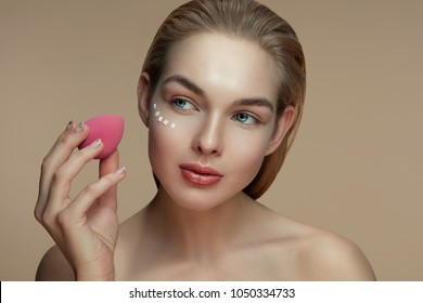 Portrait Of A Young Girl. Apply Makeup To Beauty Blender.