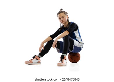 Portrait Of Young Girl, Basketball Player Sitting On Ball, Resting After Active Game Isolated Over White Studio Background. Concept Of Professional Sport, Active Lifestyle, Health, Team Game And Ad