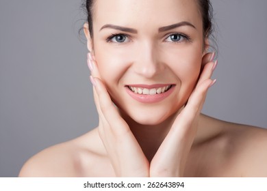 Portrait of an young girl with beautiful smile. Close-up portrait of a beautiful young woman. Skin and hair care concept. Natural look. Beauty portrait. Spa and health. - Shutterstock ID 262643894