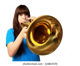 portrait of a young girl blowing trumpet on white background