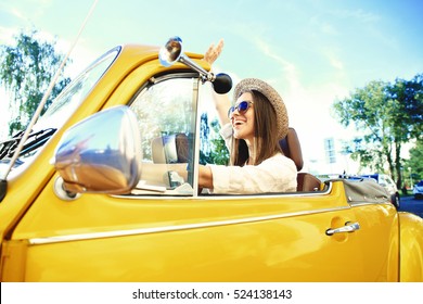 Portrait Of Young Girl Driving Cabriolet At Sunset.