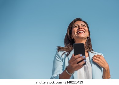 Portrait of a young girl happy with her cell phone. Copy space