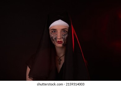 Portrait Of A Young Girl In A Hood With Creepy Face Stained With Candle Wax. Misterious Sinister Woman.