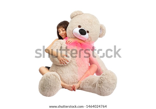 girl hugging huge teddy bear