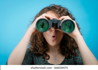 portrait of young girl looking through a binoculars