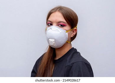 Portrait Of A Young Girl In A Medical Mask On A Gray Background, A High Level Of Respiratory Protection.