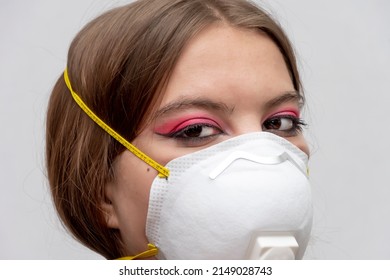 Portrait Of A Young Girl In A Medical Mask On A Gray Background, A High Level Of Respiratory Protection.