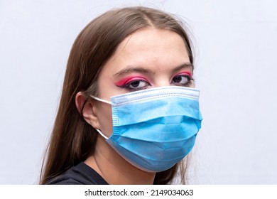 Portrait Of A Young Girl In A Medical Mask On A Gray Background, A High Level Of Respiratory Protection.