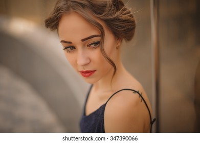 Portrait Of Young Girl With Red  Lips And Hair Up  Not Looking At The Camera Outside