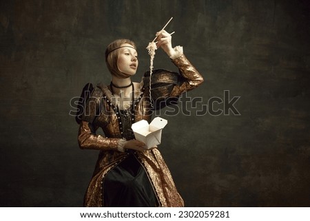Portrait of young girl, royal person, princess in vintage dress eating noodles with chopsticks against dark green background. Concept of history, renaissance art remake, comparison of eras