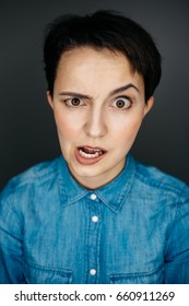 Portrait Of A Young Girl With A Short Haircut. Shocked Expression. Studio Shot