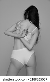 Portrait Of Young Girl With Slim Back, Tender Figure Posing In White Underwear. Black And White Photography Aesthetics. Concept Of Natural Beauty, Body And Skin Care, Femininity, Self-acceptance, Ad