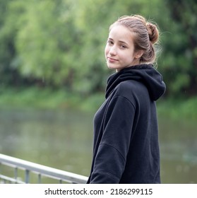 Portrait of young girl smiling. Beautiful woman standing one person outdoor. A cheerful, long brunette-haired, brown eyes female has a positive emotion: freedom of leisure activity in a natural park.