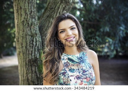 Portrait of a young girl smiling with nature background