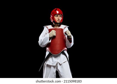 Portrait of young girl, taekwondo practitioner posing isolated over dark background. Concept of sport, education, skills, workout, health. Sportsman wearing white dobok and prtotect equipment - Powered by Shutterstock