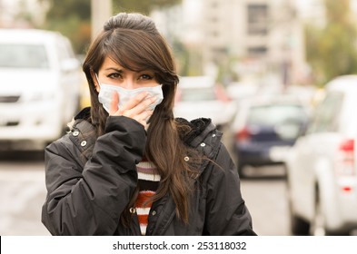 portrait of young girl walking wearing a mask in the city street concept of  pollution