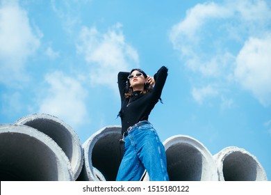 Portrait of young girl wearing sunglasses and looking at the sky 