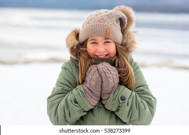 Portrait of young girl who walks outdoors on the frozen lake