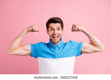 Portrait Of Young Good Mood Excited Male Showing Muscles Fit Body Superhero Isolated On Pink Color Background