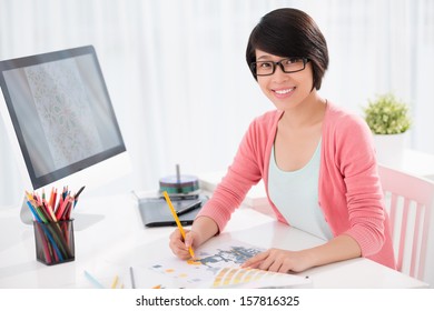 Portrait Of A Young Graphic Designer Sketching At Home On The Foreground