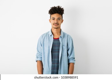 Portrait Of Young Handsome Black Man, Isolated On White Studio Background, African American Youth, Hipster Style, Student, Blue Shirt, Stylish Haircut, Cute, Looking In Camera