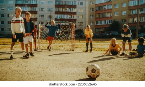 Portrait of a Young Handsome Boy Making a Penalty Kick During a Friendly Neighborhood Soccer Match with Local Kids. Talented Football Player Practicing Free Kicks in the Backyard. - Powered by Shutterstock