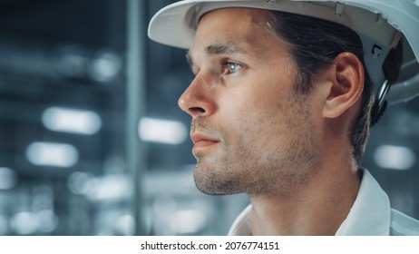 Portrait Of A Young Handsome Confident Engineer Wearing White Hard Hat In Office At Car Assembly Plant. Industrial Specialist Working On Vehicle Production In Modern Factory. Side Profile Face View.