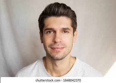 Portrait of a young handsome latin man with a slight smile and beautiful skin and hair