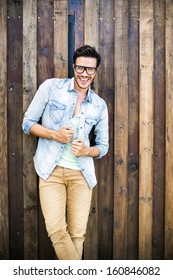 Portrait Of A Young Handsome Man, Fashion Model, With Toupee In Urban Background