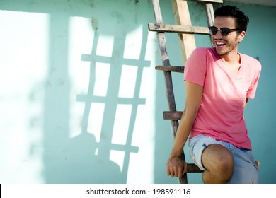 Portrait Of A Young Handsome Man, Fashion Model, With Toupee In Urban Background