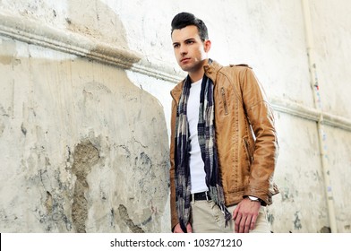 Portrait Of A Young Handsome Man, Model Of Fashion, With Toupee In Urban Background