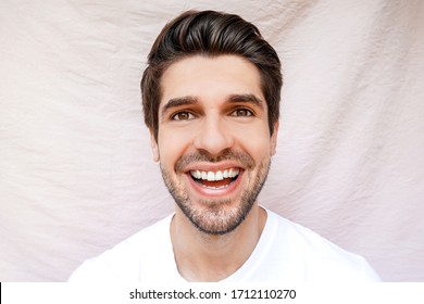 Portrait Of A Young Handsome Man With A Wide Open Big Smile 