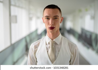 Portrait of young handsome Nonbinary businessman exploring the city of Bangkok, Thailand - Powered by Shutterstock