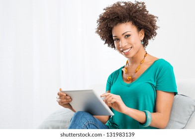 Portrait Of Young Happy African Woman Using Digital Tablet - Powered by Shutterstock