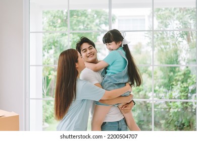 Portrait of young happy asian family spending time together at living room. - Powered by Shutterstock