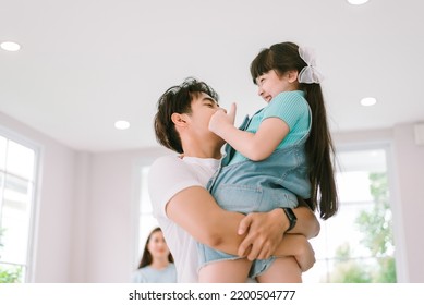 Portrait Of Young Happy Asian Family Spending Time Together At Living Room.