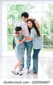 Portrait Of Young Happy Asian Family Spending Time Together At Living Room.