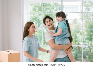 Portrait Of Young Happy Asian Family Spending Time Together At Living Room.