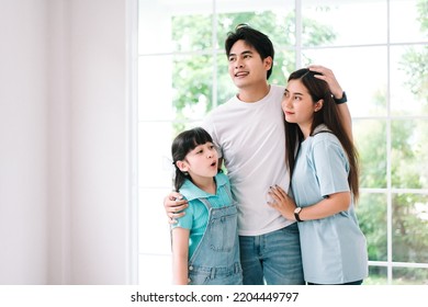 Portrait Of Young Happy Asian Family Spending Time Together At Living Room.