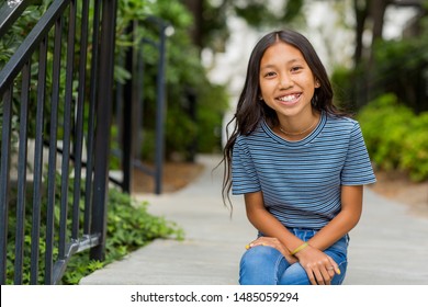 Portrait Of A Young Happy Asian Girl Smiling.